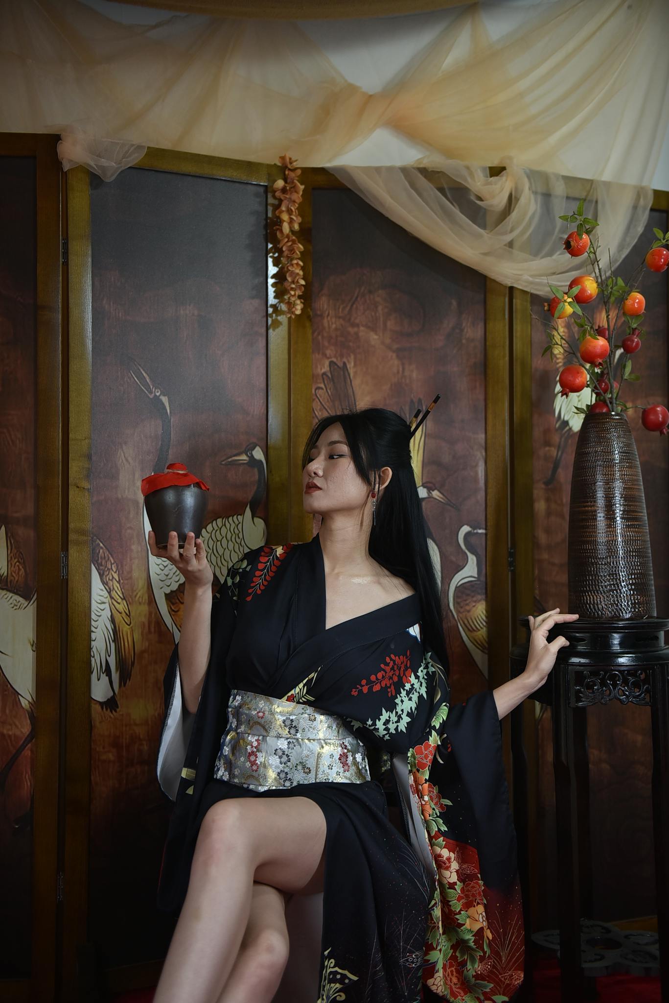 A woman in a traditional kimono poses gracefully, offering a serene and elegant ambiance.